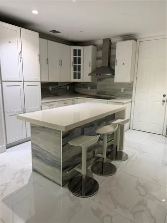 a kitchen with a table and chairs in it