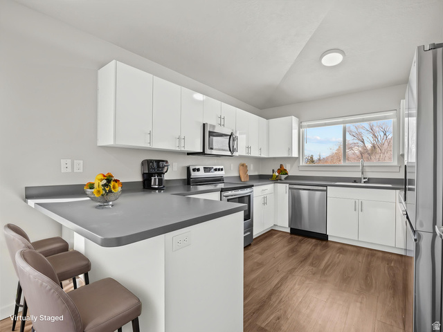 64 West 600 South, Unit C301 Springville, UT 84663 - Photo 11 of 40 Modern kitchen with white cabinetry, stainless steel appliances, and wood-finish flooring