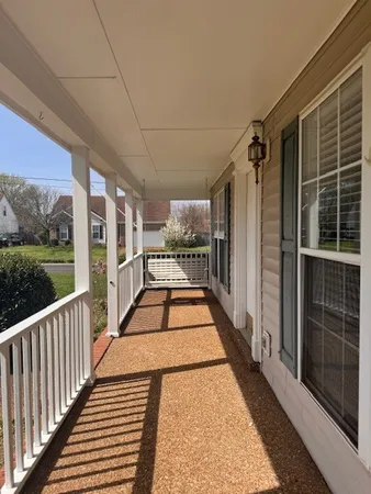a view of balcony with wooden floor and outdoor seating
