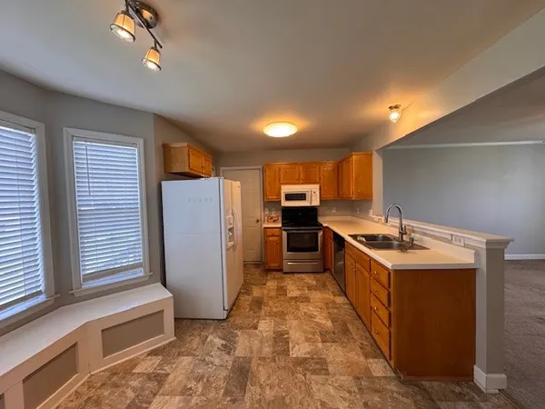 a kitchen with refrigerator and cabinets