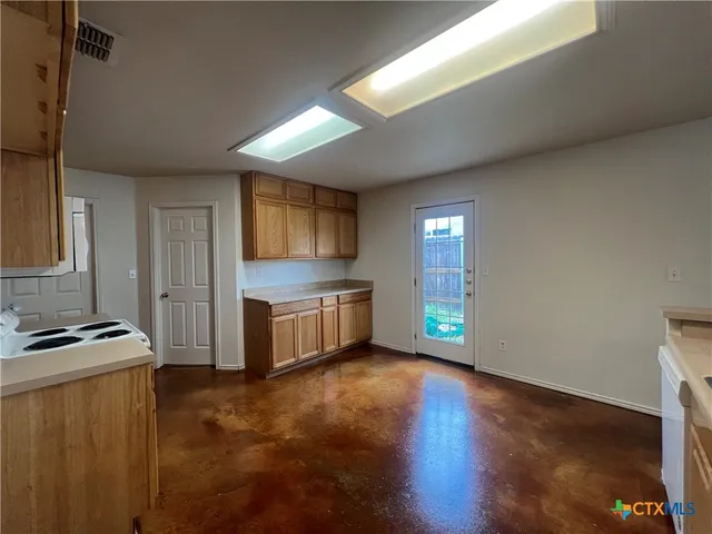 a kitchen that has a sink and a stove in it