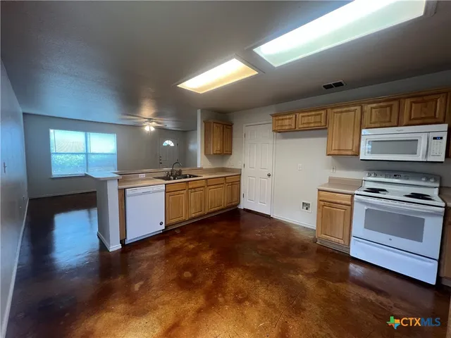 a kitchen with a stove oven and sink
