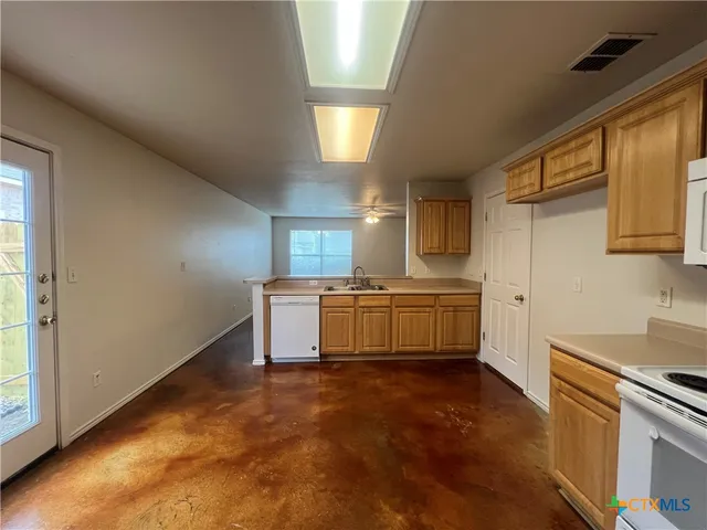a kitchen with a refrigerator and a stove
