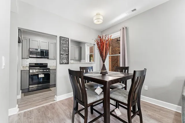 a view of a dining room with furniture and window