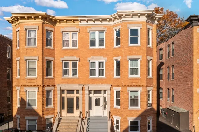 a front view of a building with a lot of windows