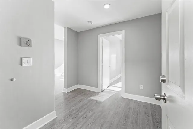 a view of a room with wooden floor