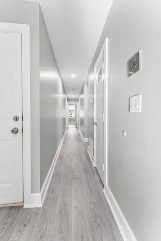 a view of hallway with wooden floor