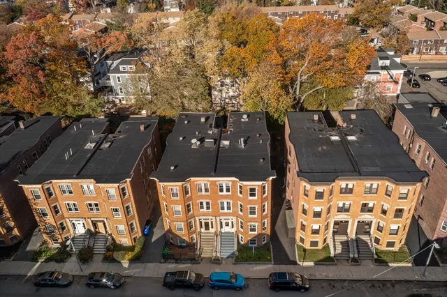 an aerial view of residential houses with outdoor space