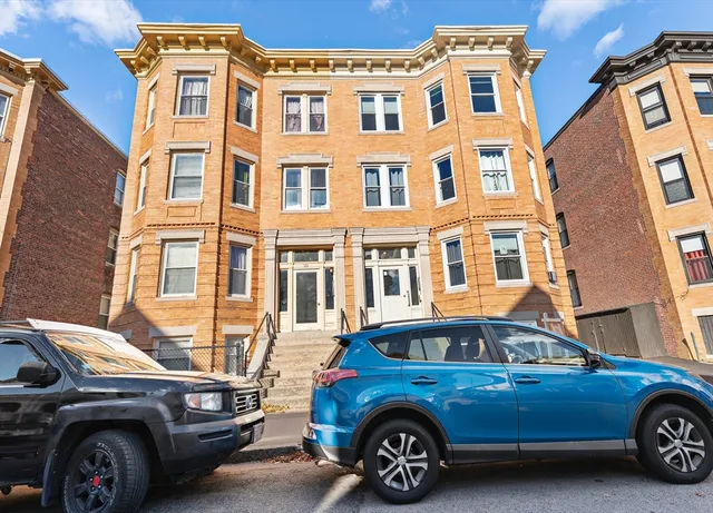 a front view of a house with parking space