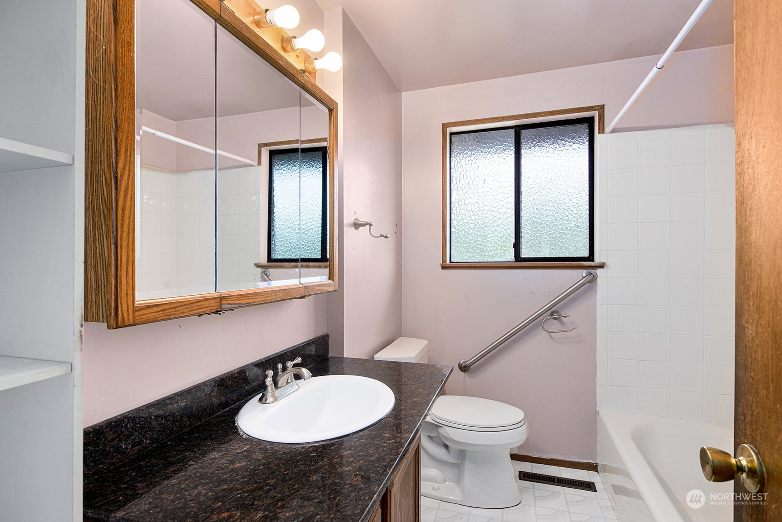 5606 Southwest 244th Street Vashon, WA 98070 - Photo 11 of 40 a bathroom with a granite countertop sink and a mirror