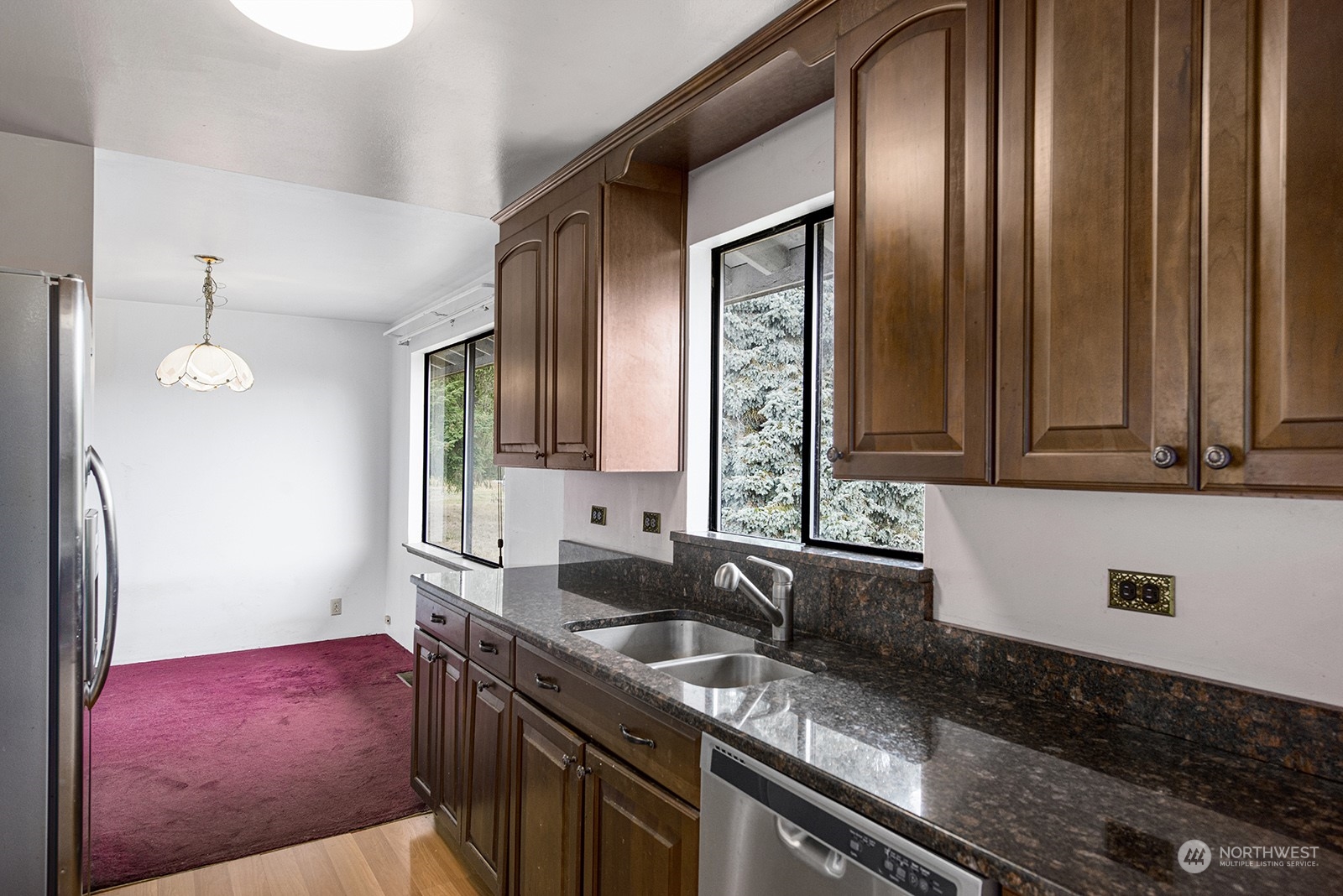 5606 Southwest 244th Street Vashon, WA 98070 - Photo 13 of 40 a kitchen with stainless steel appliances granite countertop a sink a stove and a refrigerator