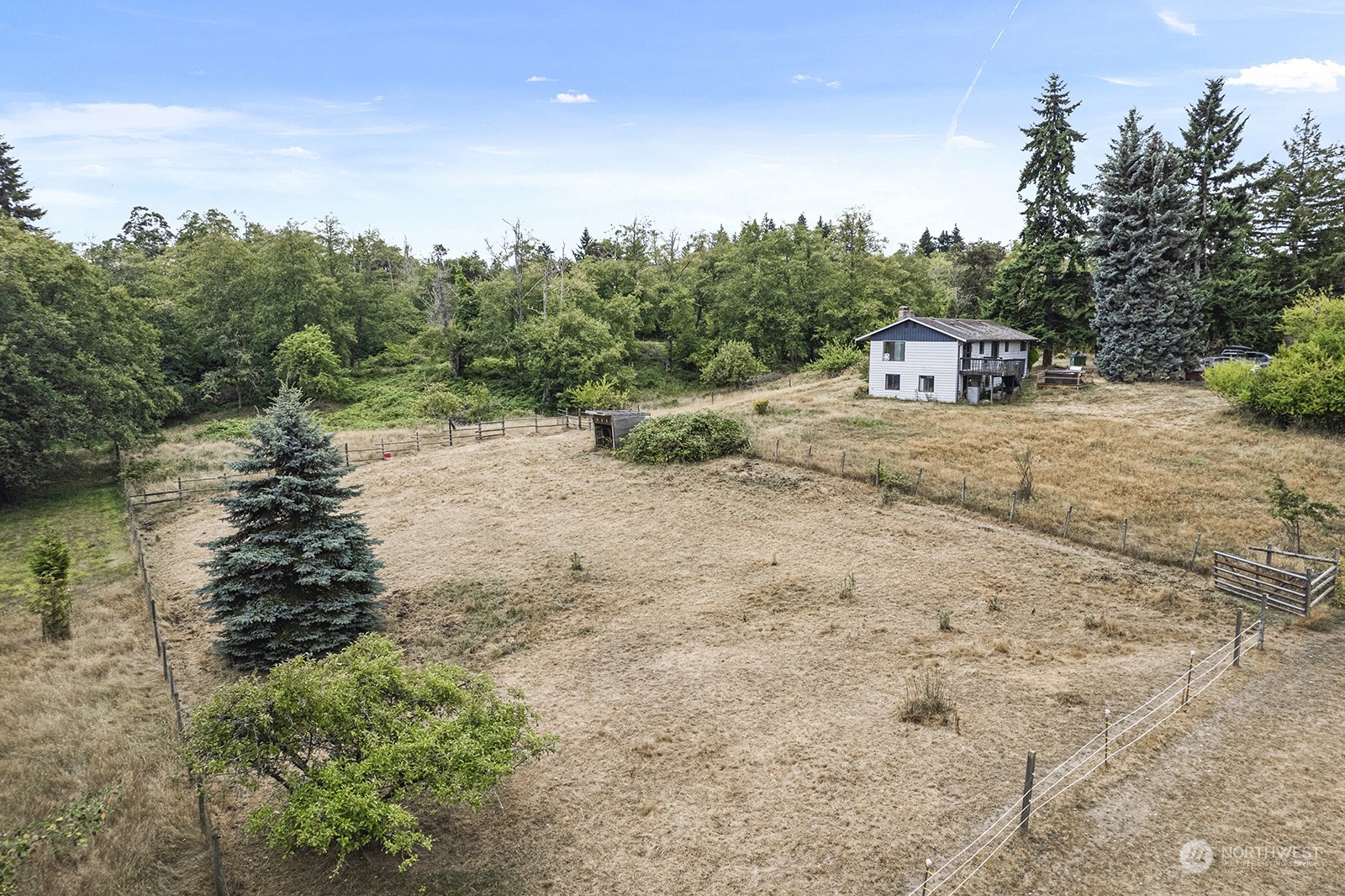 5606 Southwest 244th Street Vashon, WA 98070 - Photo 26 of 40 a dirt road with trees in the background