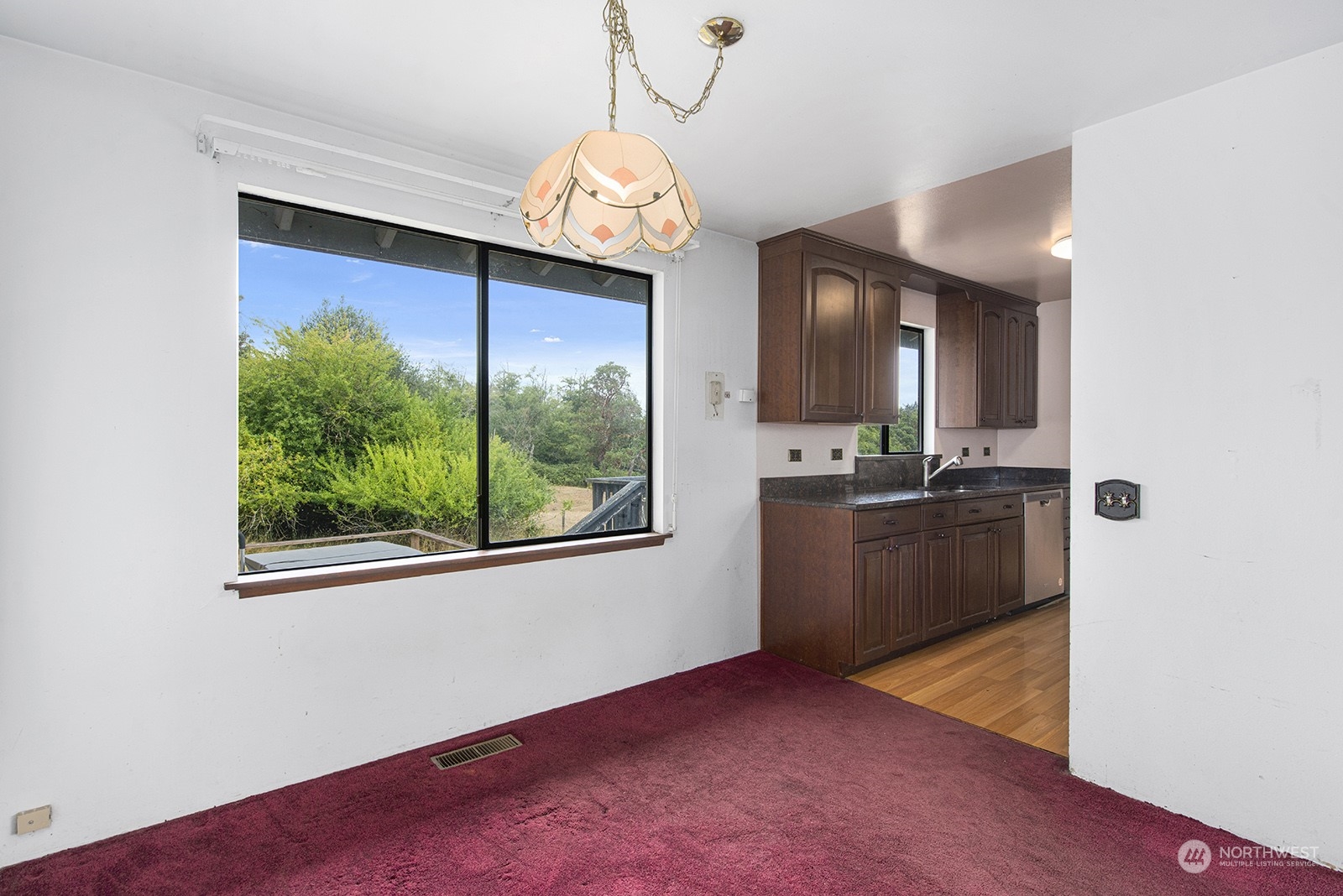 5606 Southwest 244th Street Vashon, WA 98070 - Photo 7 of 40 a view of a kitchen with kitchen island granite countertop wooden floor and stainless steel appliances