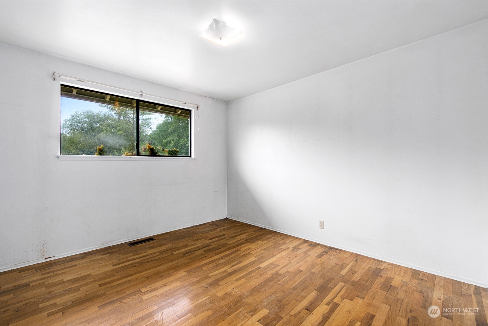 5606 Southwest 244th Street Vashon, WA 98070 - Photo 10 of 40 a view of empty room with wooden floor