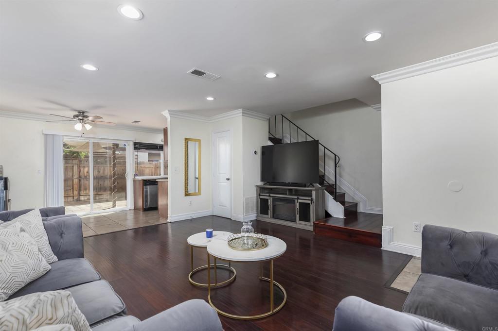 309 Sun Court El Cajon, CA 92021 - Photo 11 of 39 a living room with furniture a dining table and a flat screen tv