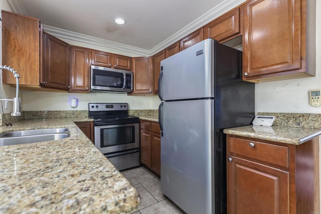 309 Sun Court El Cajon, CA 92021 - Photo 16 of 39 a kitchen with stainless steel appliances granite countertop a refrigerator stove a sink dishwasher and microwave oven