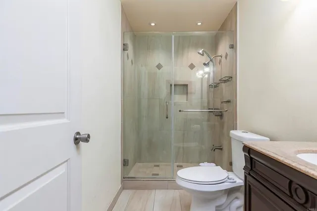 a bathroom with a shower a toilet and a sink