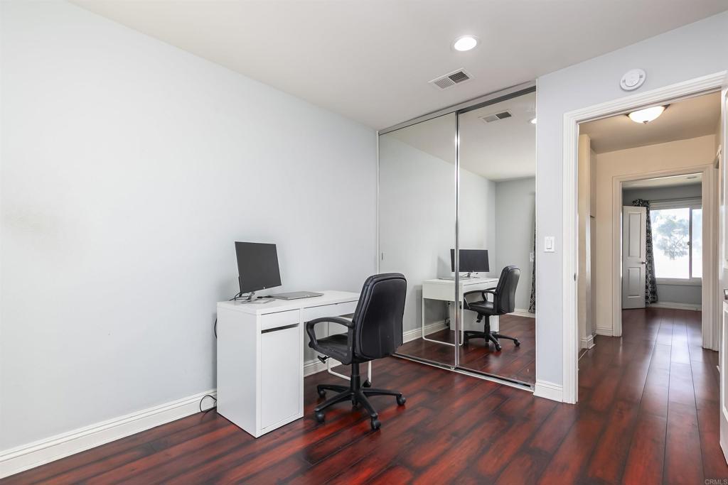 309 Sun Court El Cajon, CA 92021 - Photo 28 of 39 a view of a workspace with wooden floor and a bathroom