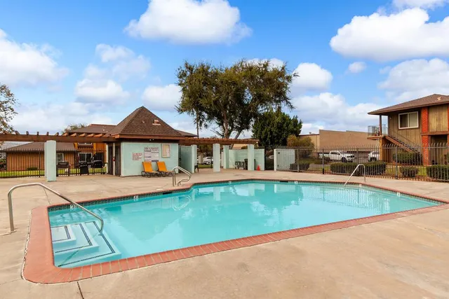 a view of a house with pool and a yard