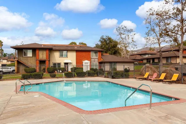 a view of a house with swimming pool and sitting area