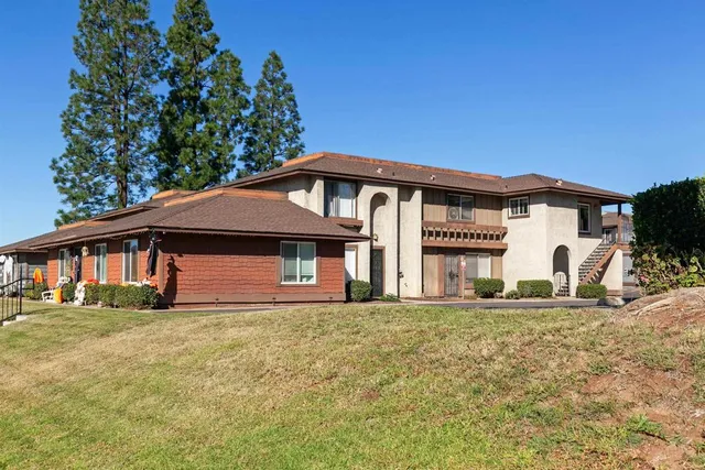 a front view of a house with a garden