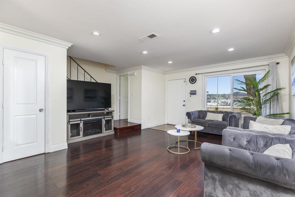 309 Sun Court El Cajon, CA 92021 - Photo 8 of 39 a living room with furniture a flat screen tv and kitchen view