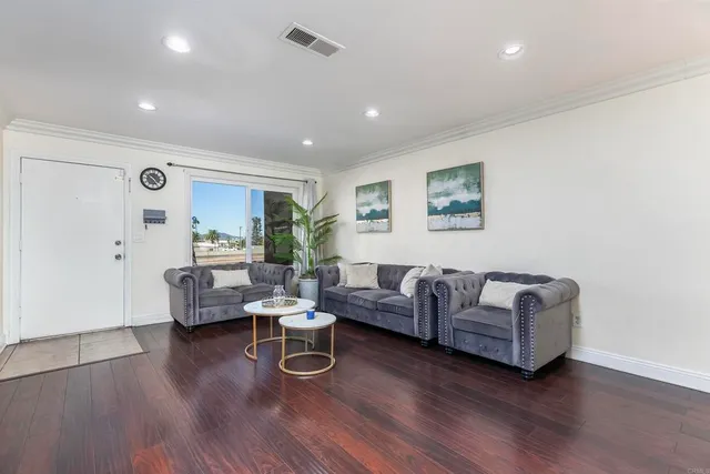 a living room with furniture and wooden floor