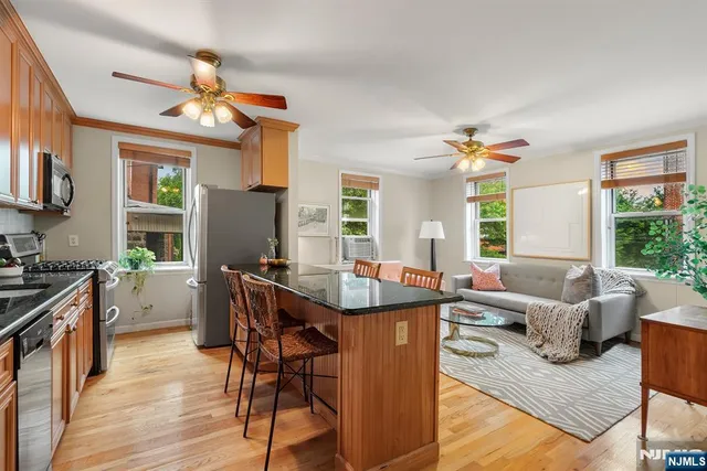 a view of a dining room with furniture a chandelier and wooden floor