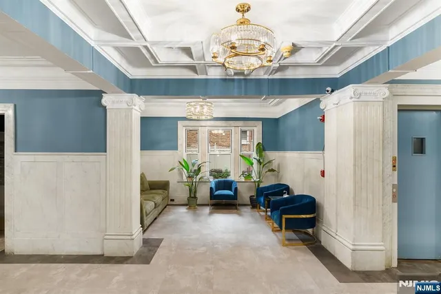 a living room with furniture chandelier and a chandelier