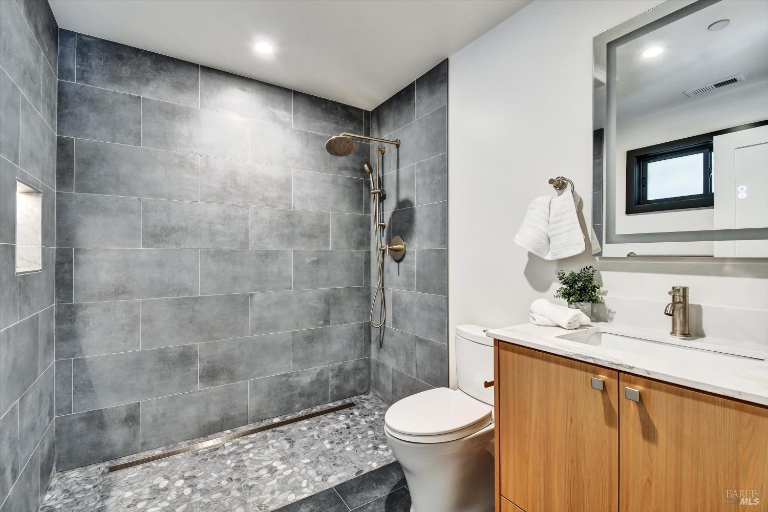 148 Auburn Street San Rafael, CA 94901 - Photo 20 of 40 Second bedroom bath with beautiful tile and river rock bottom for a reflexology effect