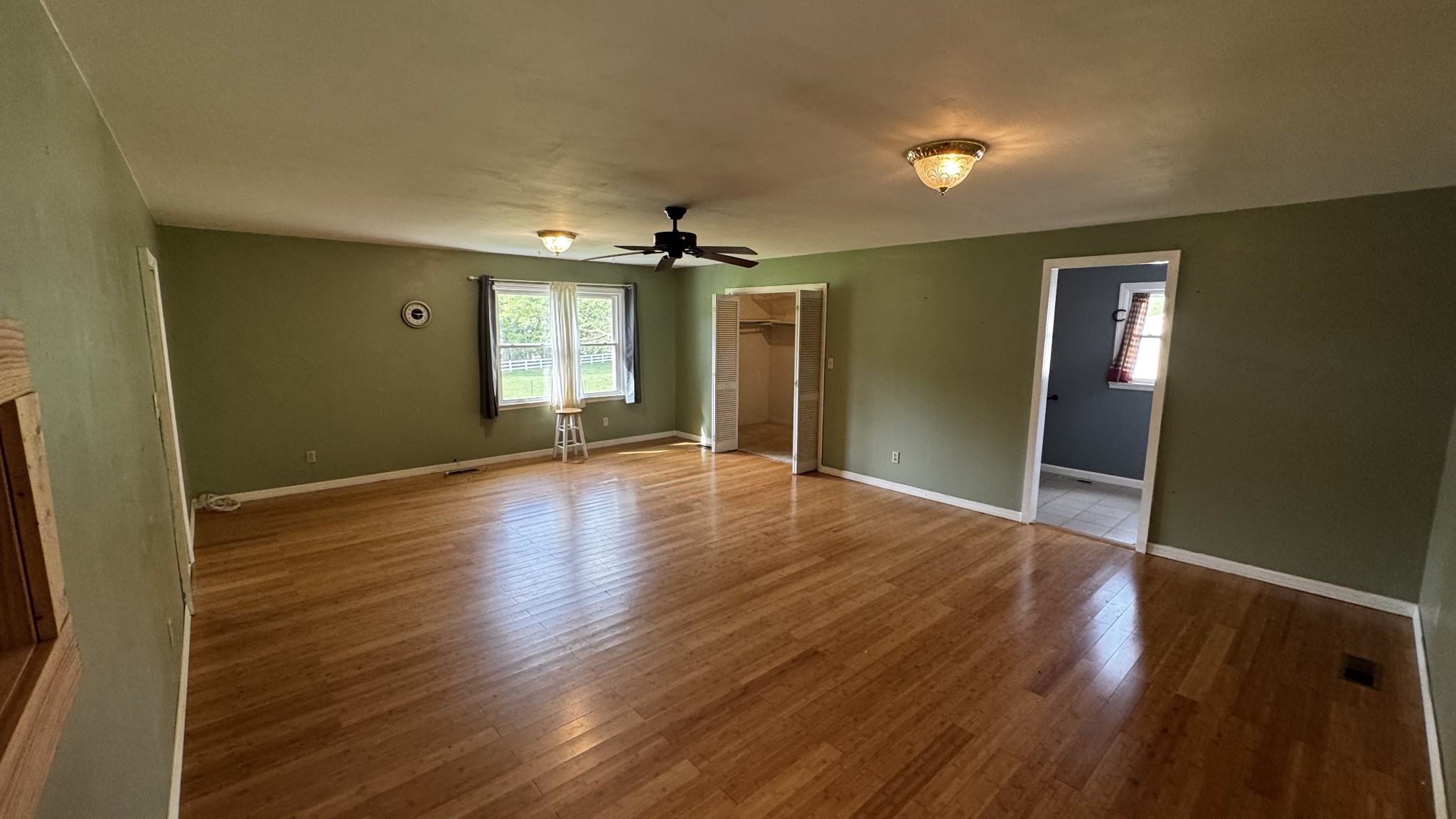 315 Loyd Road Pulaski, TN 38478 - Photo 12 of 73 an empty room with wooden floor and windows