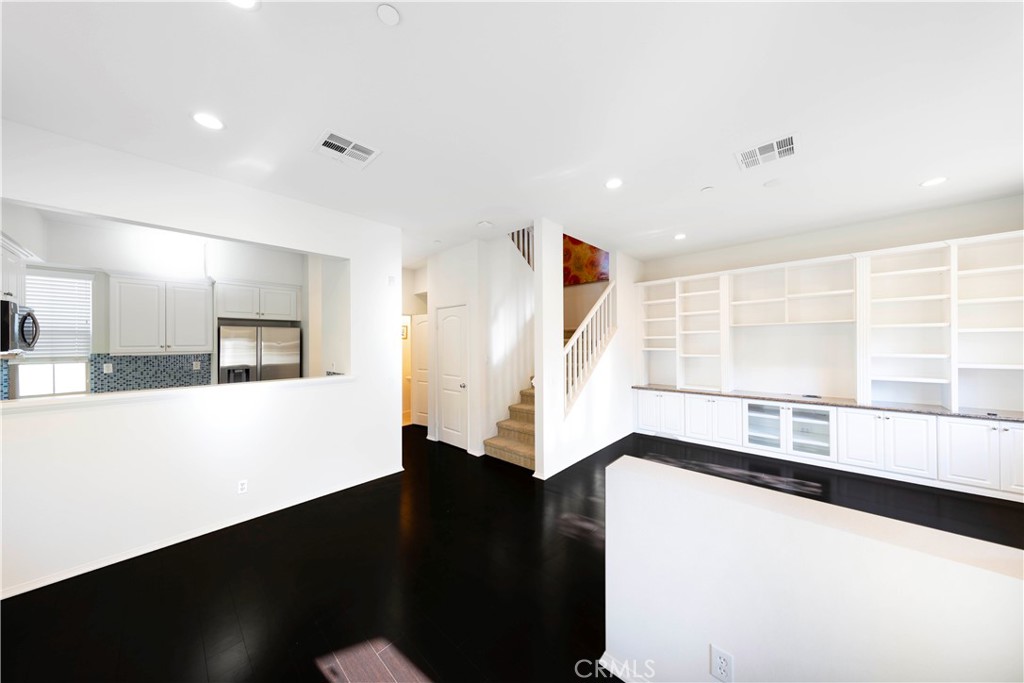 90 Hedge Bloom Irvine, CA 92618 - Photo 3 of 22 a view of an empty room with wooden floor and a window