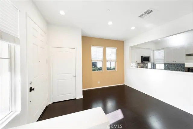 a view of kitchen with granite countertop cabinets and sink