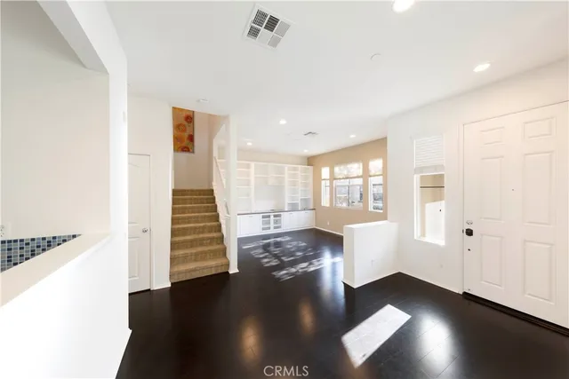 a view of an entryway with wooden floor and windows