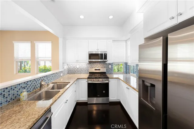 a kitchen with a stove a sink and a refrigerator