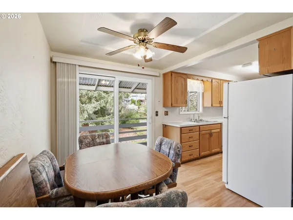 a living room with stainless steel appliances kitchen island granite countertop furniture and a large window