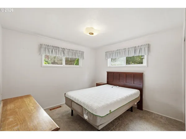 a bedroom with a bed and a table