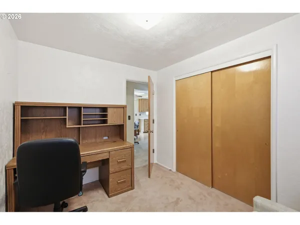 a kitchen with a refrigerator and cabinets