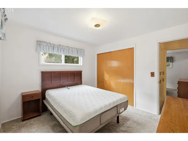 a bedroom with a bed and a table