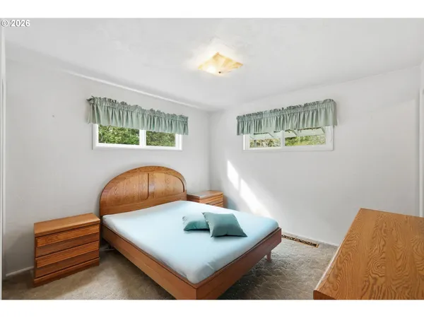 a bedroom with a bed and window