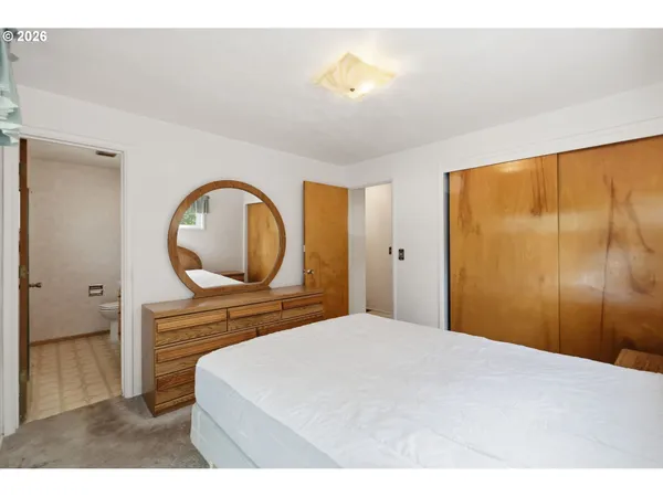 a bedroom with a bed and a dresser