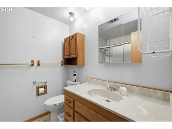 a bathroom with a sink a toilet and mirror