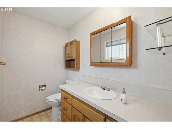 a bathroom with a sink a toilet and mirror
