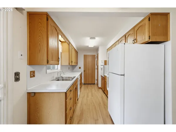 a kitchen with a sink a refrigerator freezer a washer and dryer