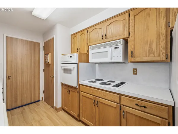 a kitchen with stainless steel appliances granite countertop a refrigerator and cabinets