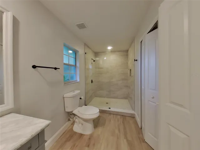 a bathroom with a toilet and a shower