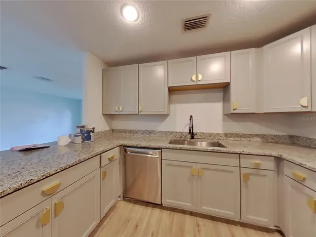 a kitchen with sink cabinets and window