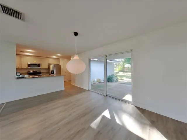 a view of a room with wooden floor