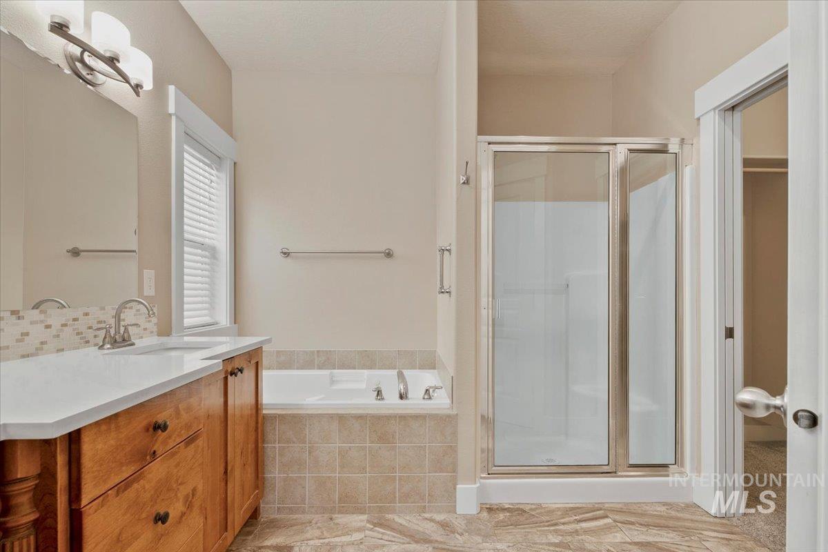 2264 East Comisky Street Meridian, ID 83646 - Photo 21 of 47 Full bath featuring a bath, a stall shower, and vanity