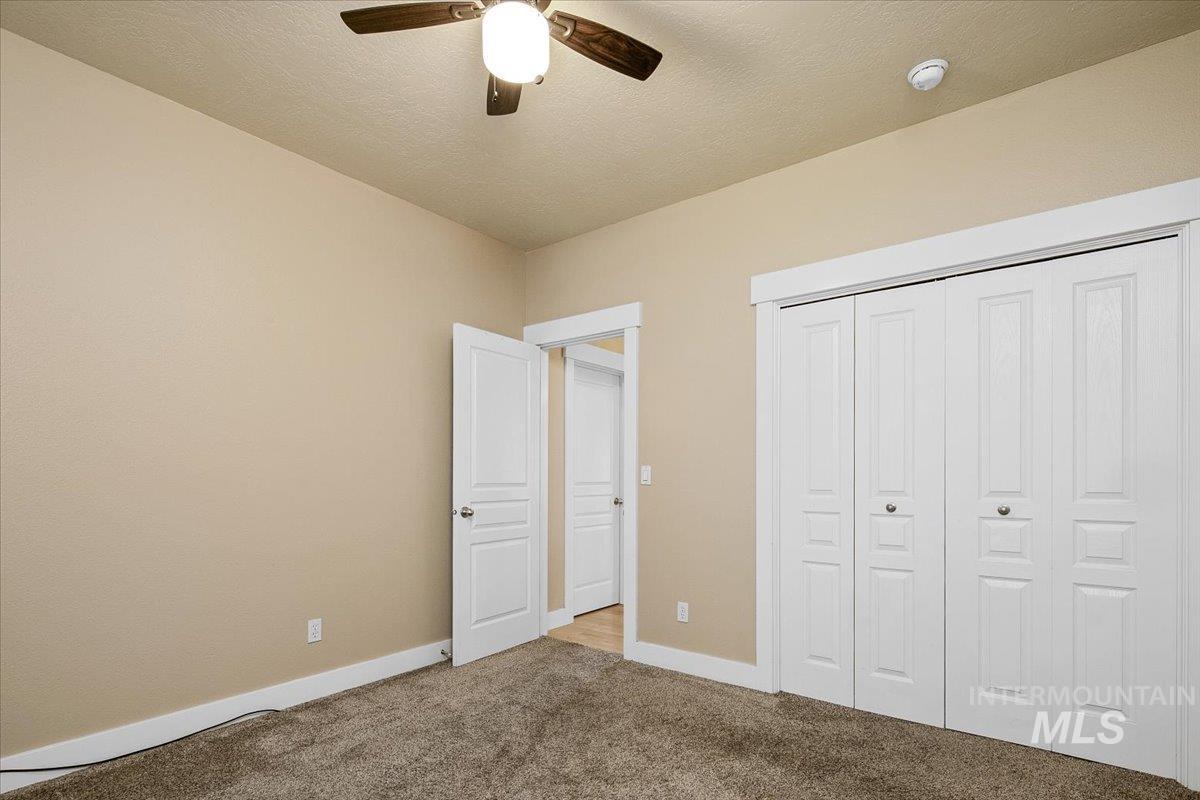 2264 East Comisky Street Meridian, ID 83646 - Photo 26 of 47 Unfurnished bedroom featuring carpet floors, a closet, ceiling fan, and a textured ceiling